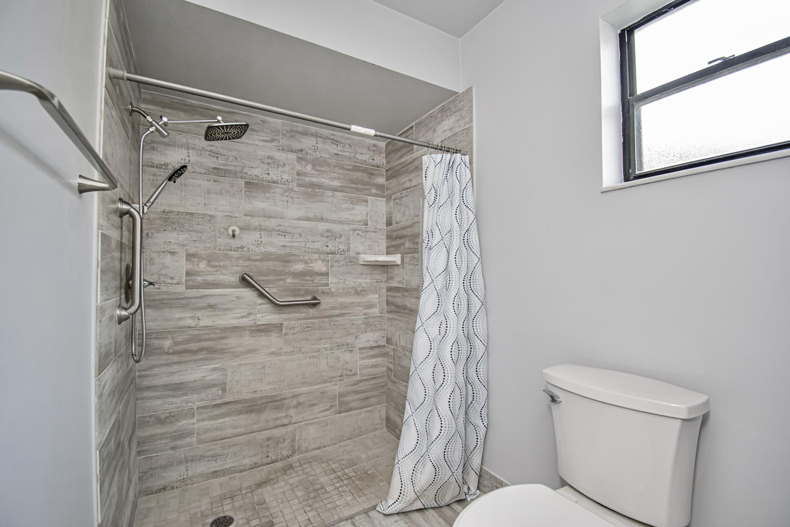 7706 Solimar Circle Boca Raton, FL 33433 - Photo 19 of 28 a bathroom with a shower and a toilet