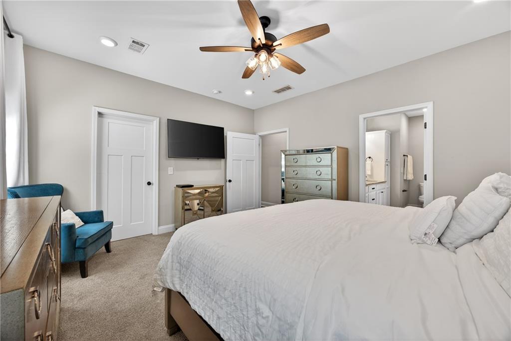 30 Buffelhead Court Monticello, GA 31064 - Photo 17 of 37 a bedroom with a bed and a flat screen tv