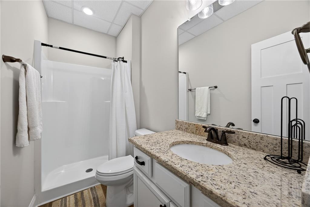 30 Buffelhead Court Monticello, GA 31064 - Photo 23 of 37 a bathroom with a granite countertop sink toilet and shower