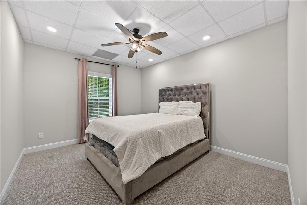 30 Buffelhead Court Monticello, GA 31064 - Photo 24 of 37 a bed room with a bed and a ceiling fan