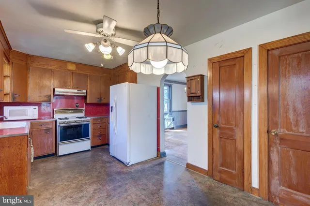 a view of a kitchen with a sink stainless steel appliances and cabinets