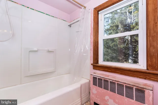 a bathroom with a bathtub and a shower