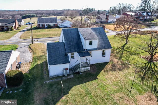 an aerial view of a house with garden space and lake view