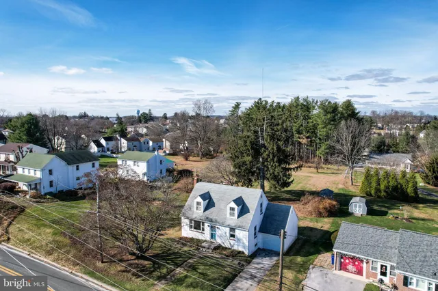 an aerial view of a house with a yard and lake view