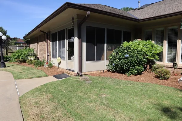 a view of a house with a backyard and sitting area