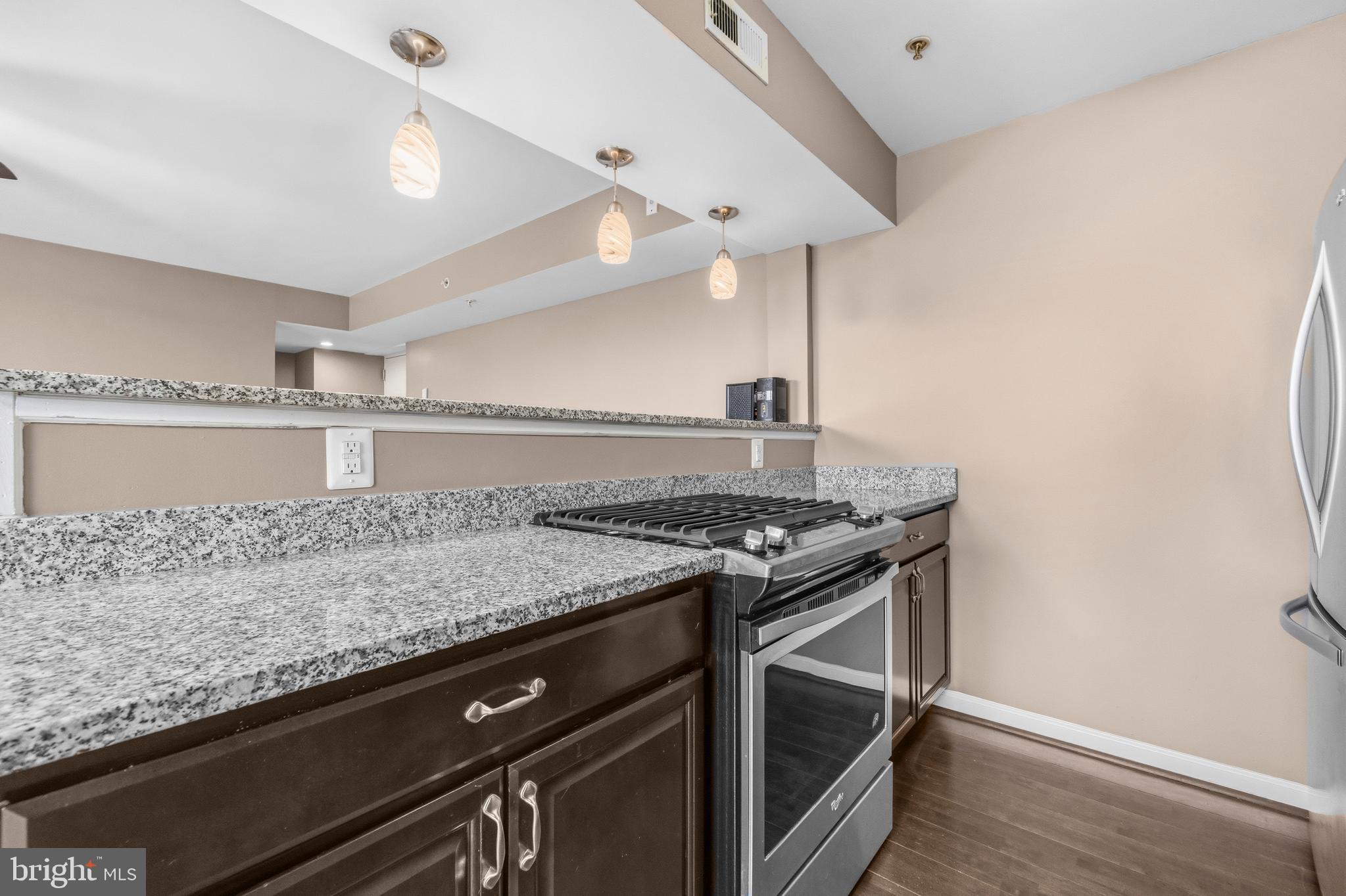 3902 14th Street Northwest, Unit 321 Washington, DC 20011 - Photo 12 of 21 a kitchen with granite countertop a stove and a sink
