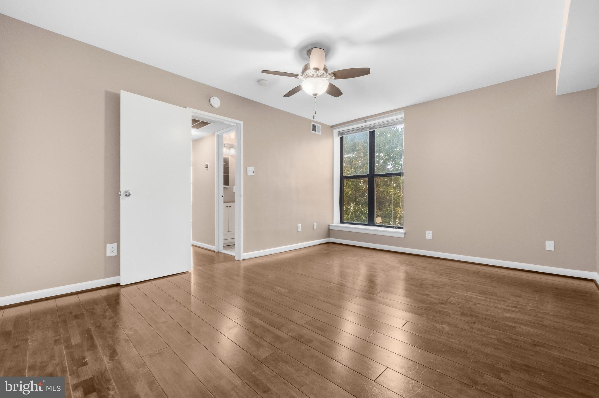 3902 14th Street Northwest, Unit 321 Washington, DC 20011 - Photo 16 of 21 a view of an empty room with wooden floor and a window