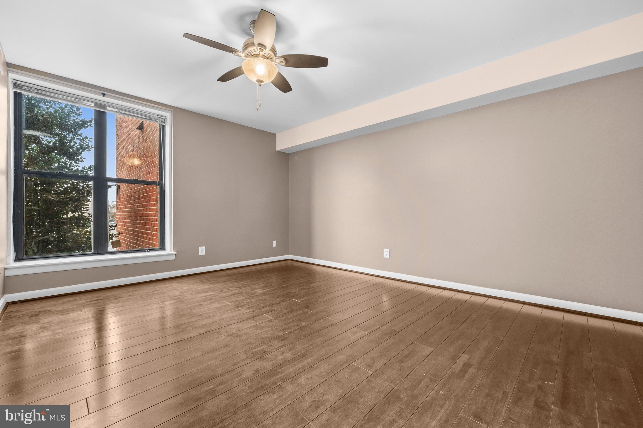 3902 14th Street Northwest, Unit 321 Washington, DC 20011 - Photo 17 of 21 a view of an empty room with a window and wooden floor