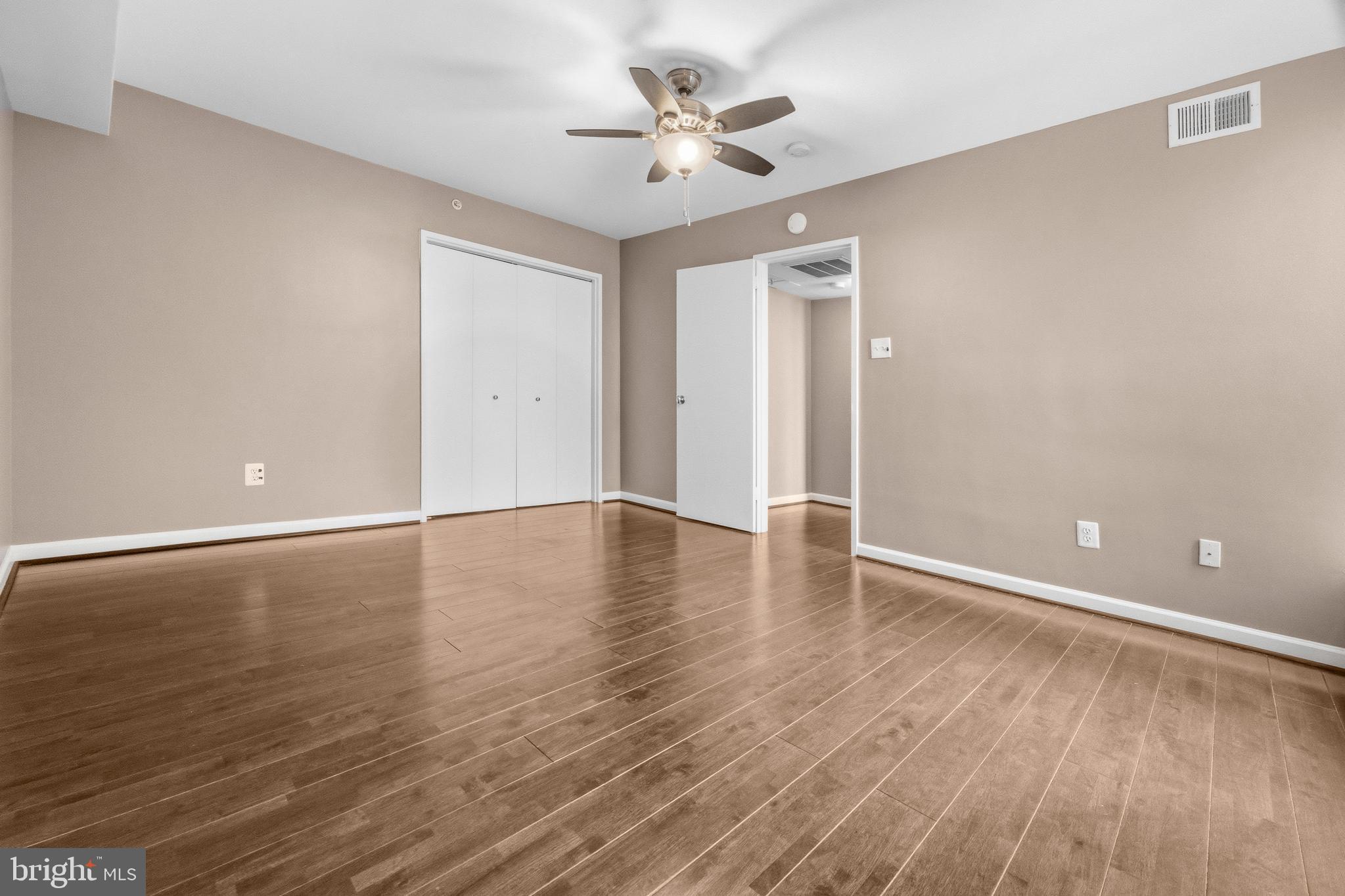3902 14th Street Northwest, Unit 321 Washington, DC 20011 - Photo 18 of 21 wooden floor in an empty room with a window