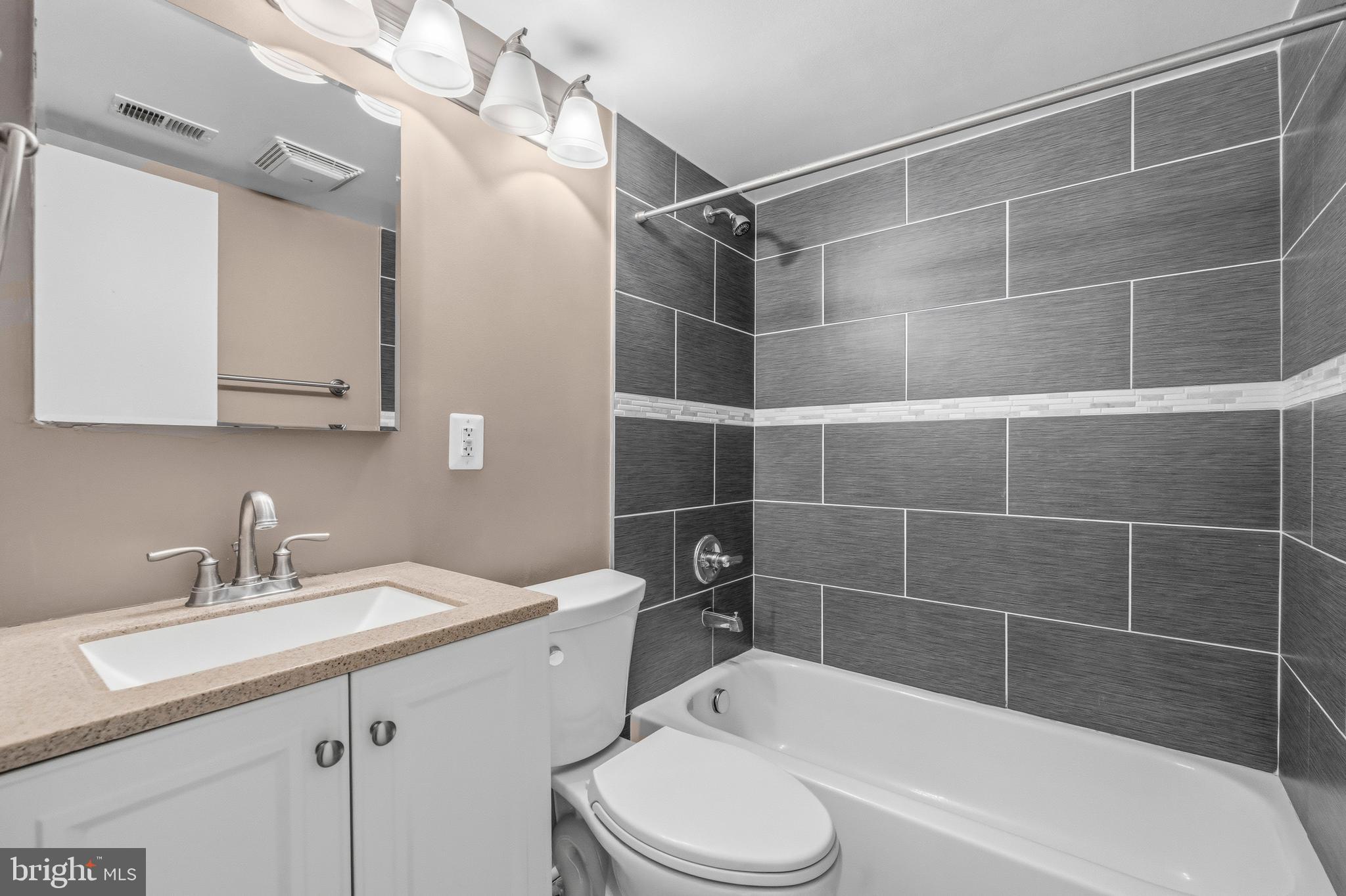 3902 14th Street Northwest, Unit 321 Washington, DC 20011 - Photo 19 of 21 a bathroom with a sink toilet vanity and bathtub
