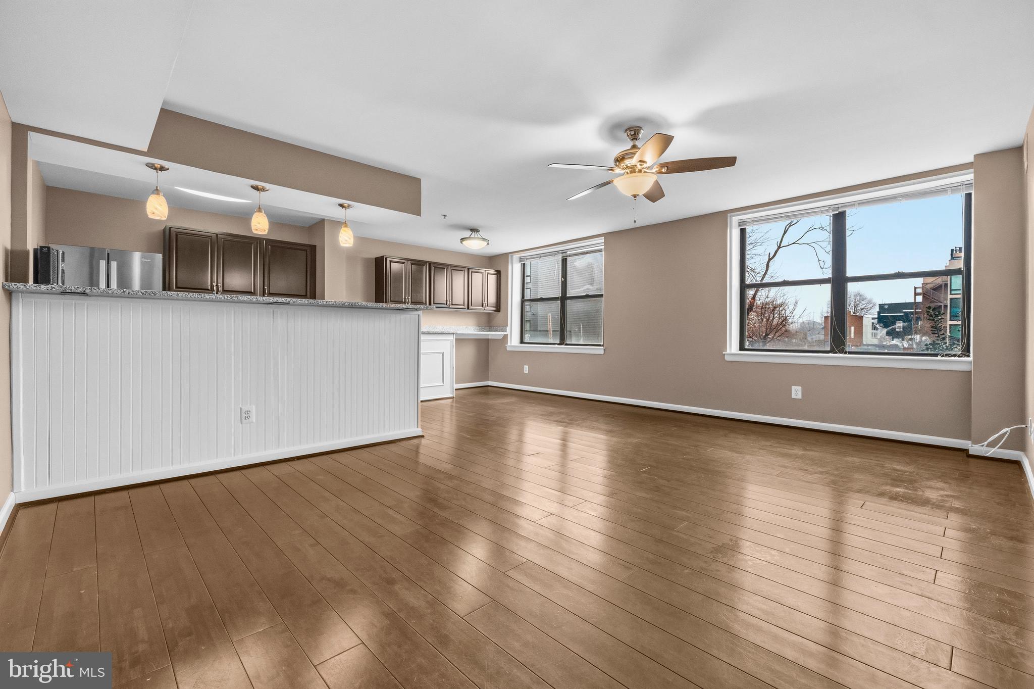 3902 14th Street Northwest, Unit 321 Washington, DC 20011 - Photo 2 of 21 a view of an empty room with window and wooden floor