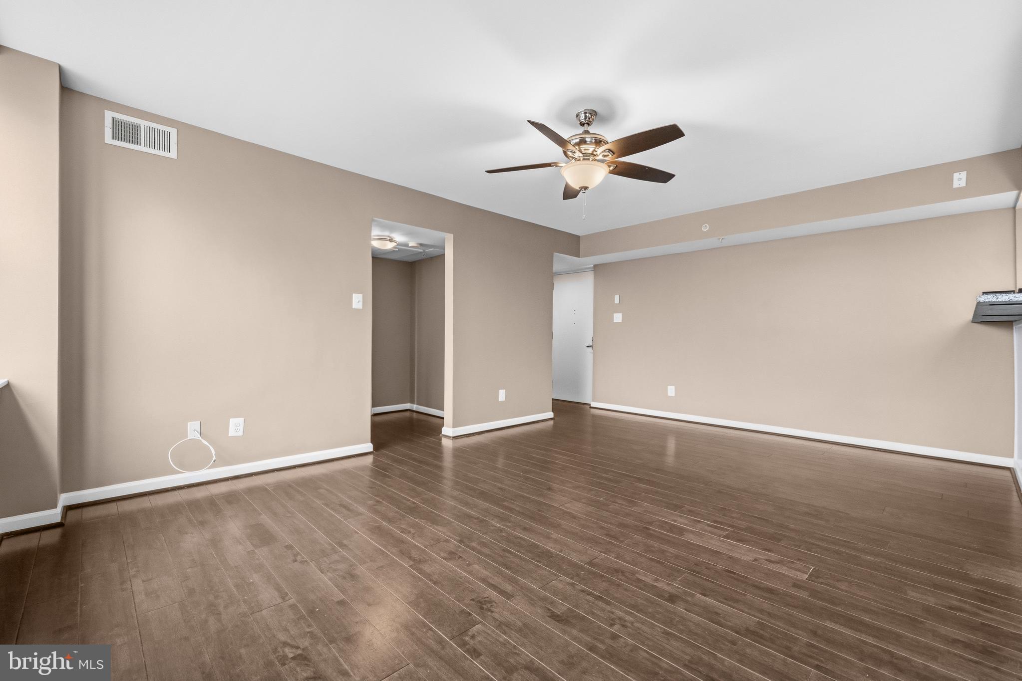 3902 14th Street Northwest, Unit 321 Washington, DC 20011 - Photo 7 of 21 an empty room with wooden floor fan and windows