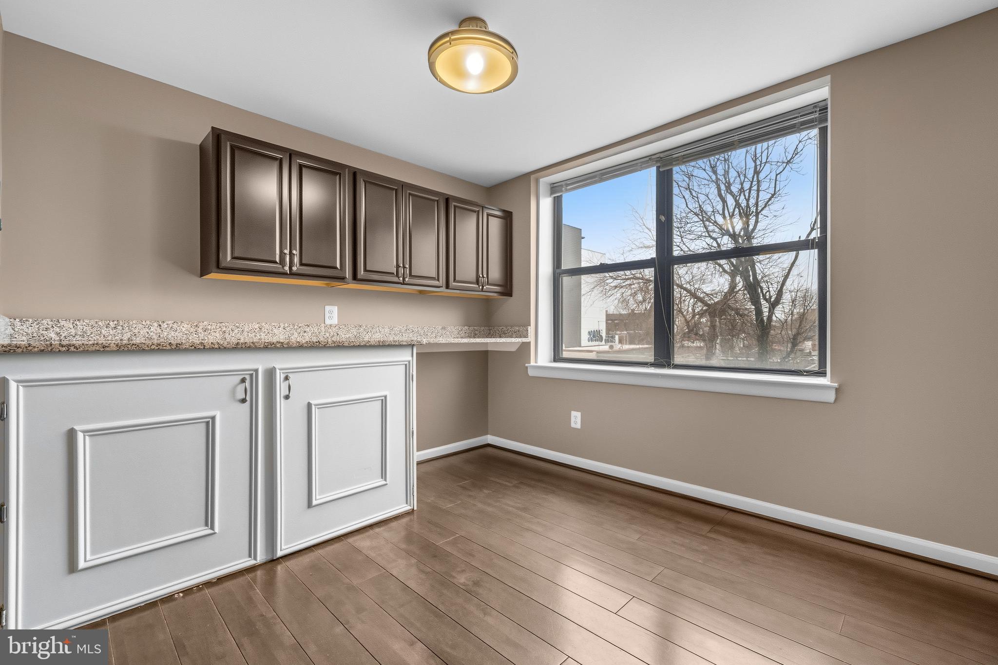 3902 14th Street Northwest, Unit 321 Washington, DC 20011 - Photo 8 of 21 a kitchen with wooden cabinets and a window