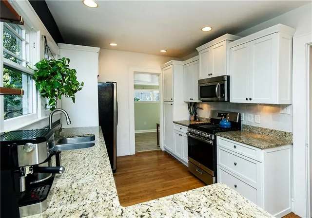 a kitchen with a sink a counter space and appliances