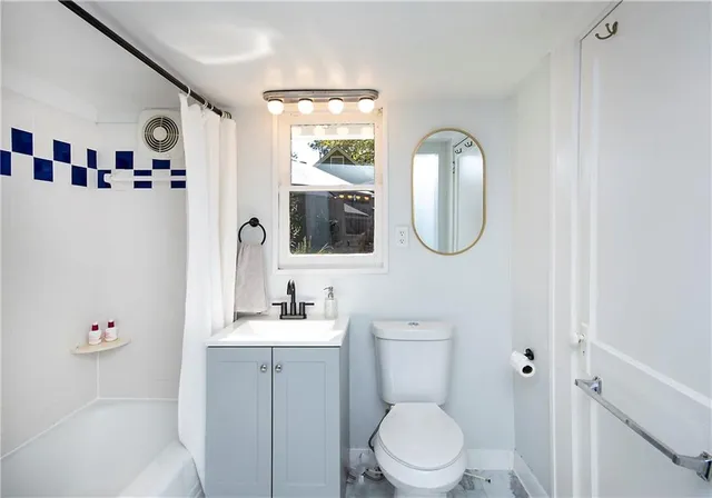 a living room with furniture a fireplace and a chandelier