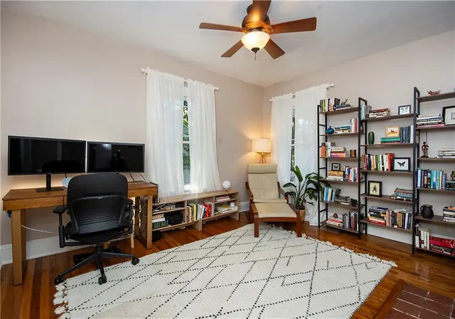 a view of a livingroom with wooden floor and a window