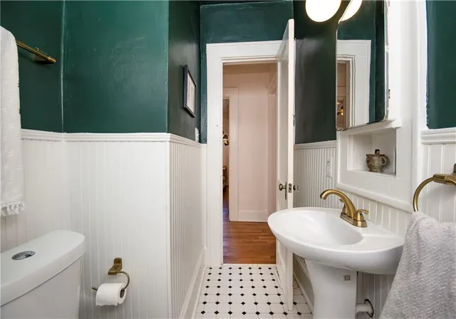 an empty room with wooden floor fireplace and windows