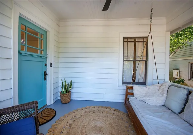 a view of a roof deck with couches and potted plants