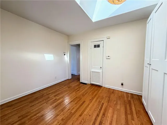 a front view of a house with a yard and potted plants