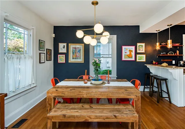 a kitchen with stainless steel appliances kitchen island granite countertop a refrigerator a stove a sink and a microwave