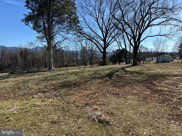 a backyard of a house with large trees