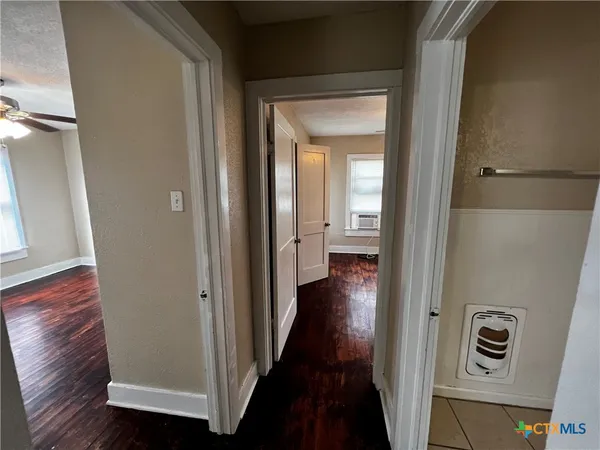 a view of a hallway with wooden floor