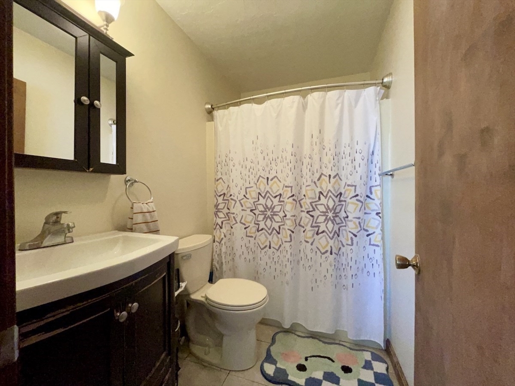 15 Burghardt Street, Unit B Worcester, MA 01604 - Photo 11 of 30 a bathroom with a sink and a mirror