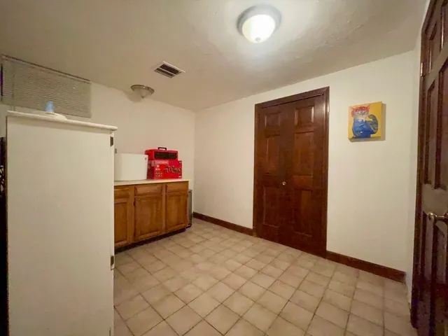 a kitchen with a refrigerator and window