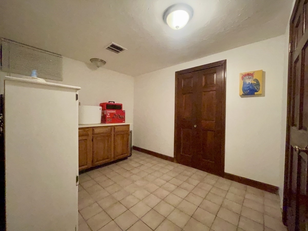 15 Burghardt Street, Unit B Worcester, MA 01604 - Photo 14 of 30 a kitchen with a refrigerator and window