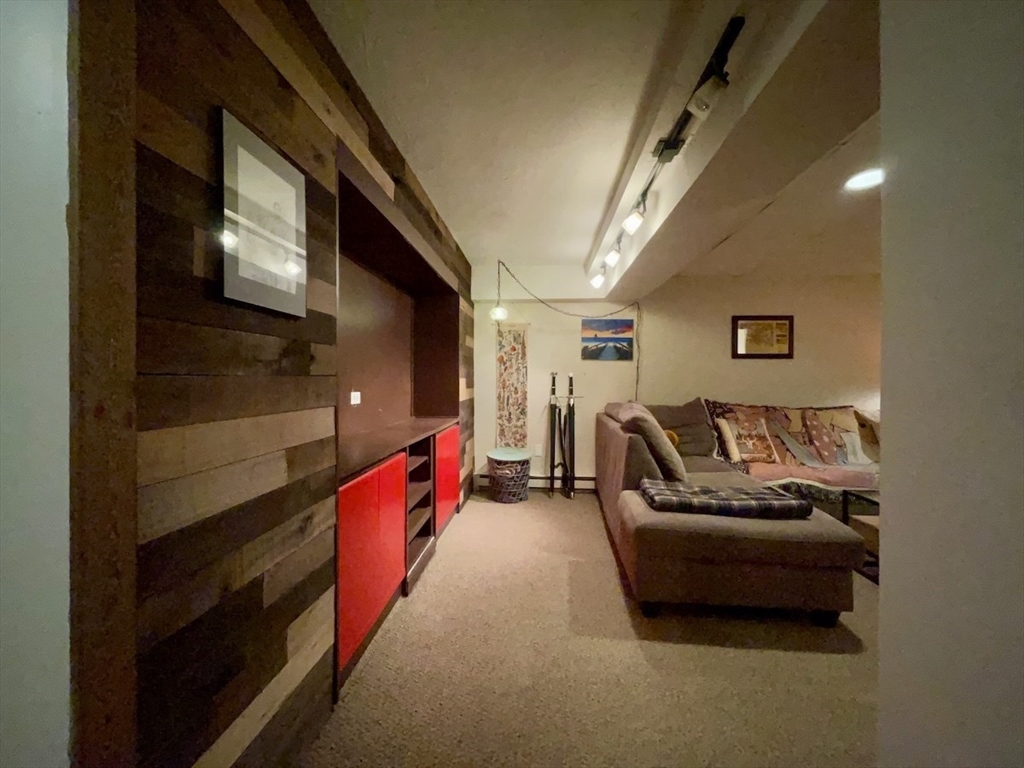 15 Burghardt Street, Unit B Worcester, MA 01604 - Photo 17 of 30 a living room with furniture and a flat screen tv
