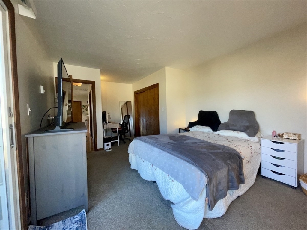 15 Burghardt Street, Unit B Worcester, MA 01604 - Photo 20 of 30 a bedroom with a bed and mirror