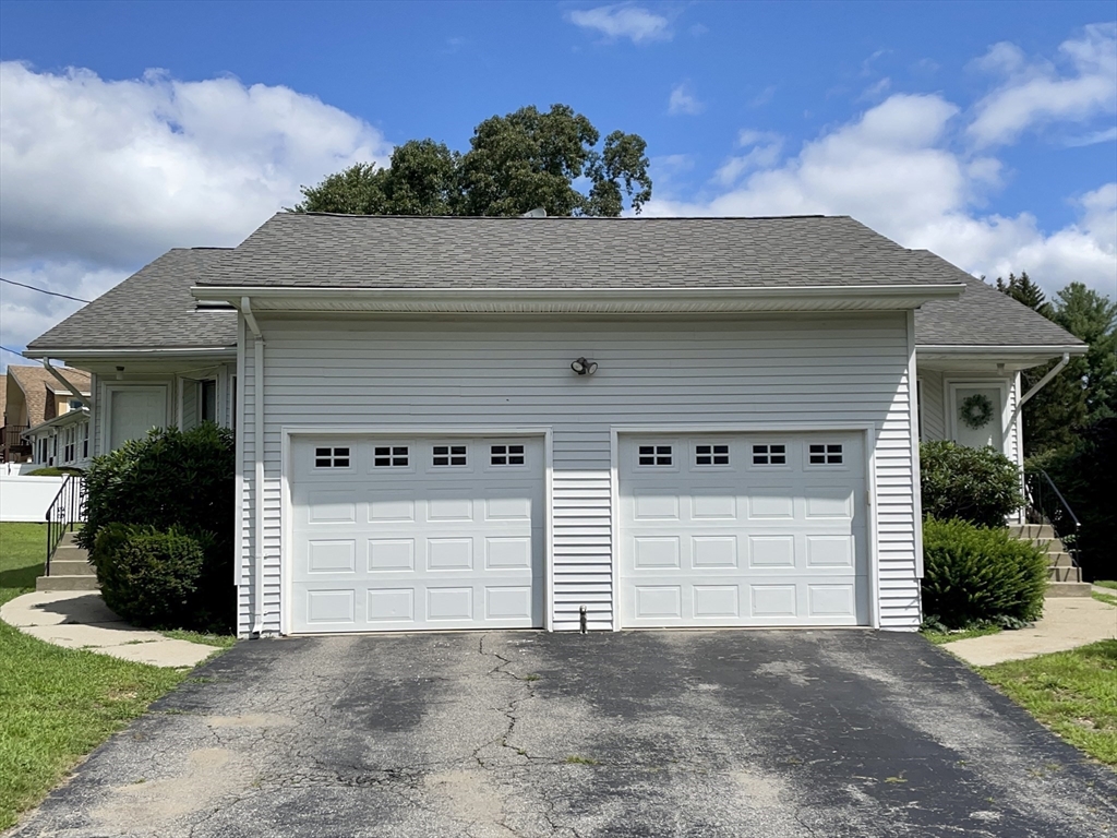 15 Burghardt Street, Unit B Worcester, MA 01604 - Photo 2 of 30 a front view of a house with a yard and garage