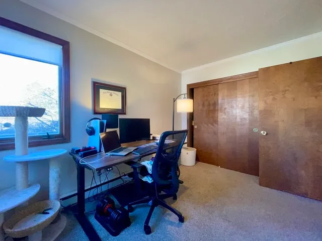 a work room with furniture and a window