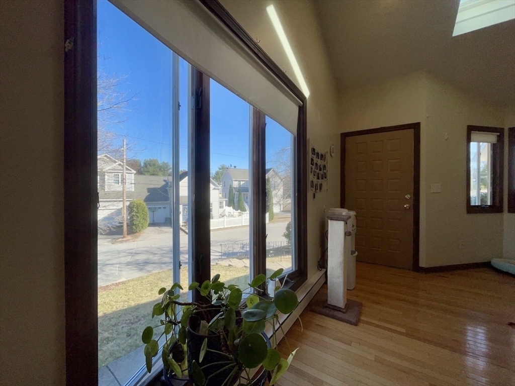 15 Burghardt Street, Unit B Worcester, MA 01604 - Photo 6 of 30 a view of a livingroom with wooden floor and a floor to ceiling window