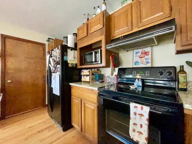 a kitchen with stainless steel appliances granite countertop a stove and a refrigerator