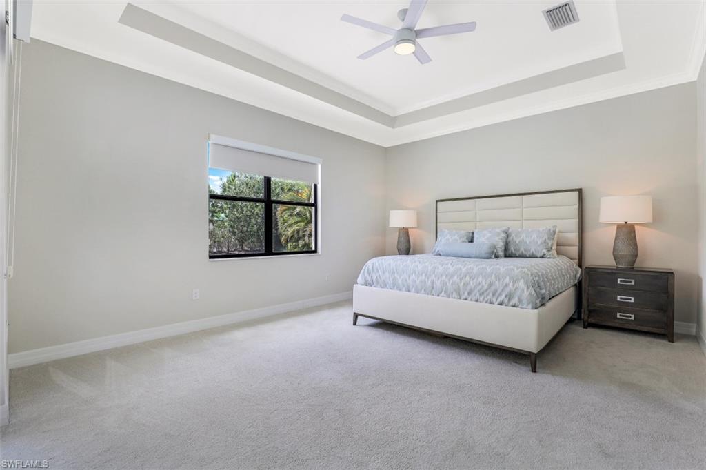 2134 Antigua Lane Naples, FL 34120 - Photo 12 of 31 a bedroom with a bed and a window