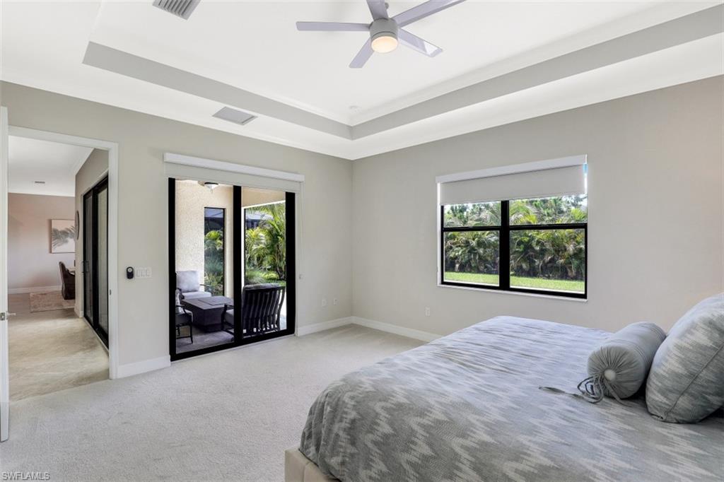2134 Antigua Lane Naples, FL 34120 - Photo 13 of 31 a bedroom with a bed and a large window
