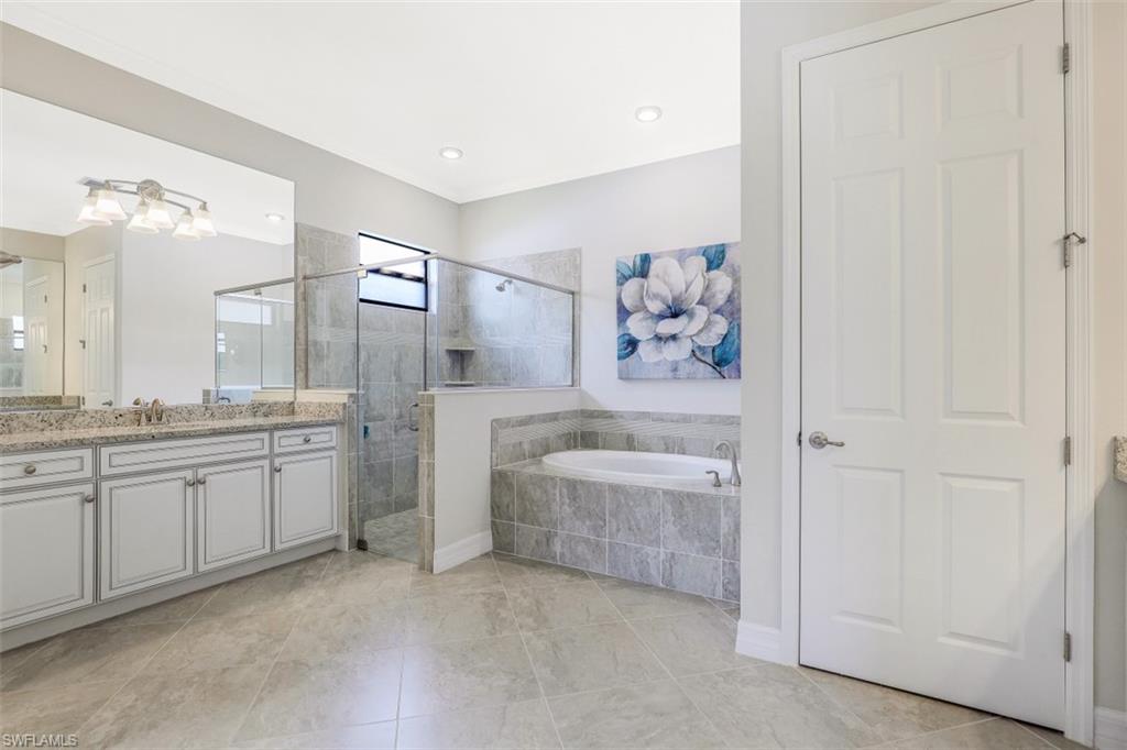 2134 Antigua Lane Naples, FL 34120 - Photo 14 of 31 a spacious bathroom with a granite countertop sink a toilet and bathtub