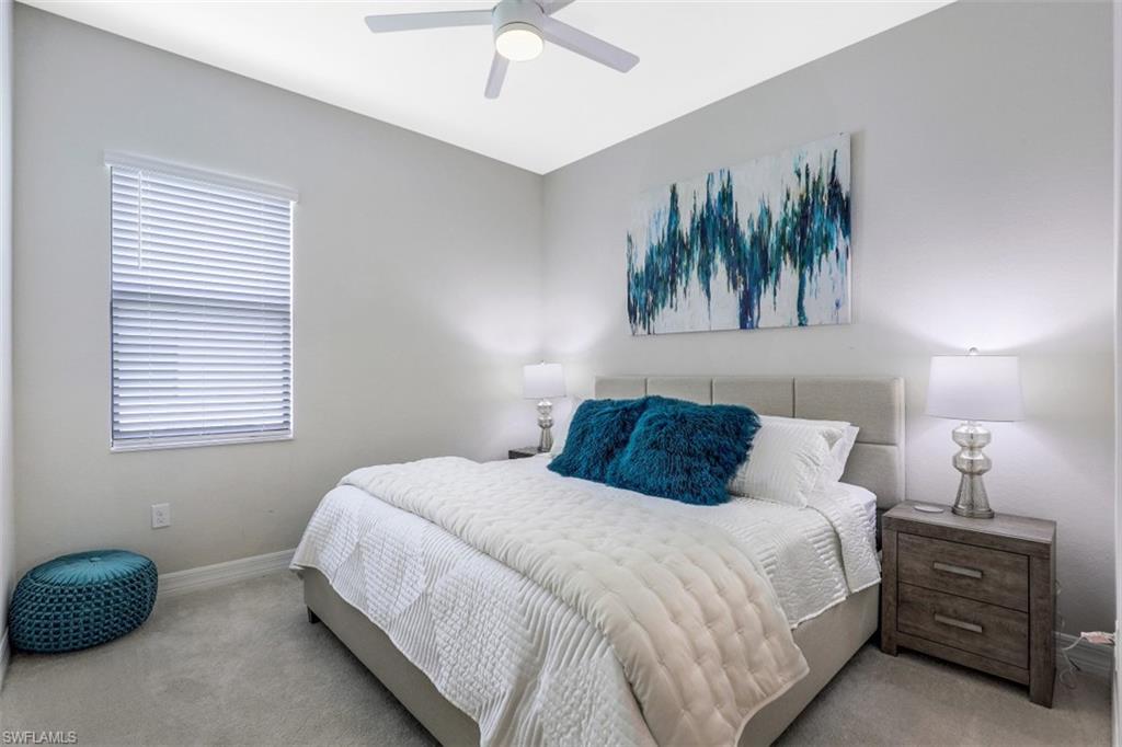 2134 Antigua Lane Naples, FL 34120 - Photo 16 of 31 a bedroom with a bed and a window