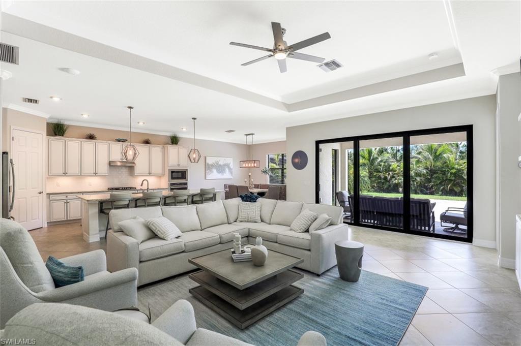 2134 Antigua Lane Naples, FL 34120 - Photo 2 of 31 a living room with furniture and a large window with kitchen view