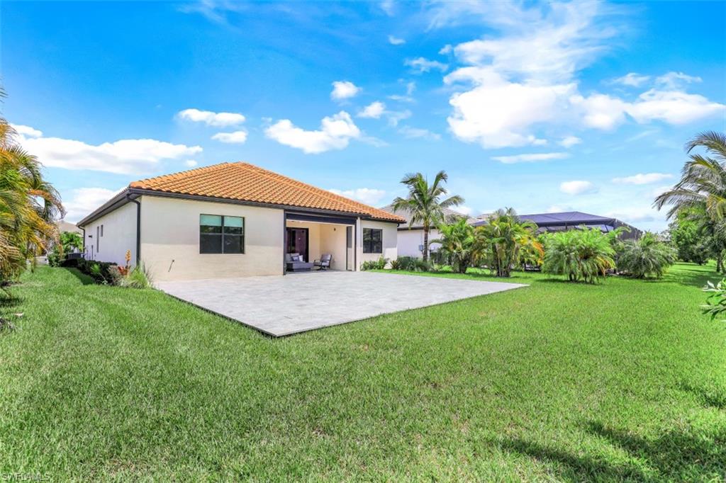 2134 Antigua Lane Naples, FL 34120 - Photo 25 of 31 a front view of a house with a garden