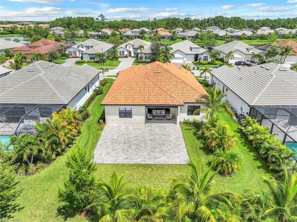 2134 Antigua Lane Naples, FL 34120 - Photo 28 of 31 an aerial view of multiple houses with a big yard