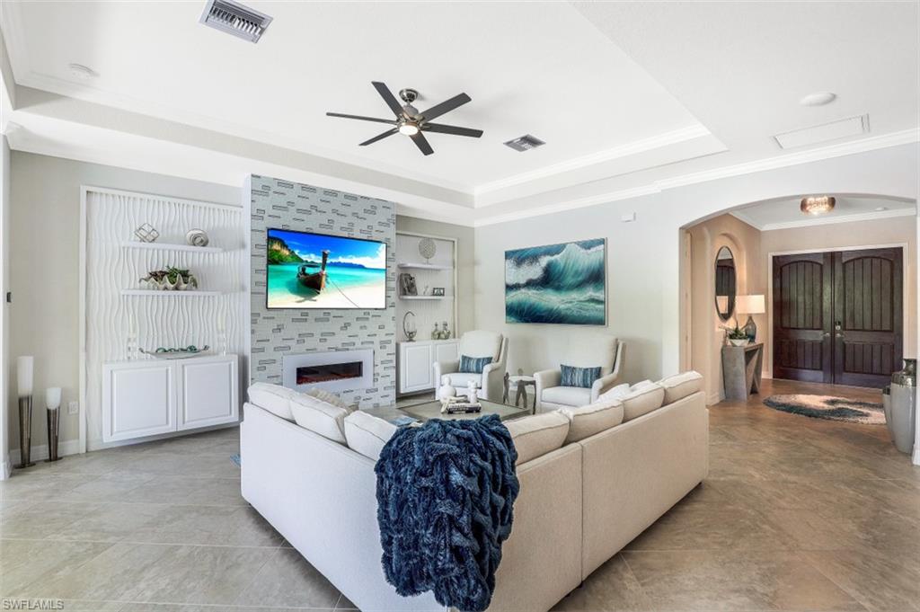 2134 Antigua Lane Naples, FL 34120 - Photo 3 of 31 a living room with furniture and a fireplace