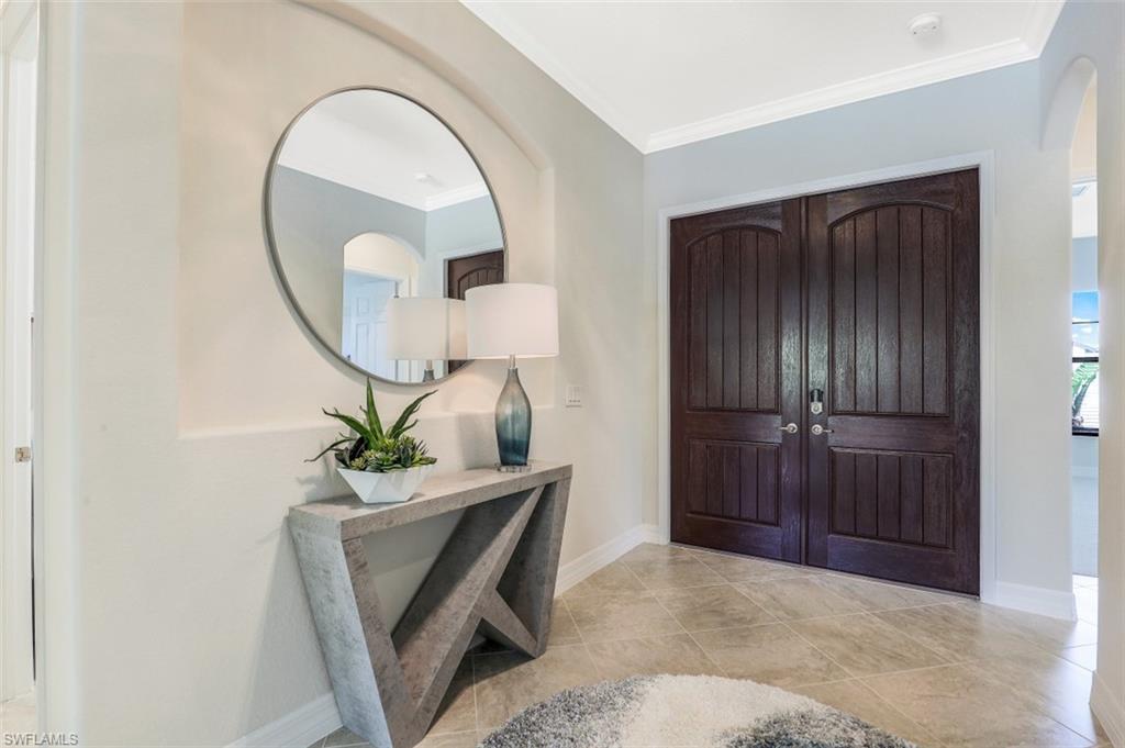 2134 Antigua Lane Naples, FL 34120 - Photo 4 of 31 a living room with furniture and a mirror