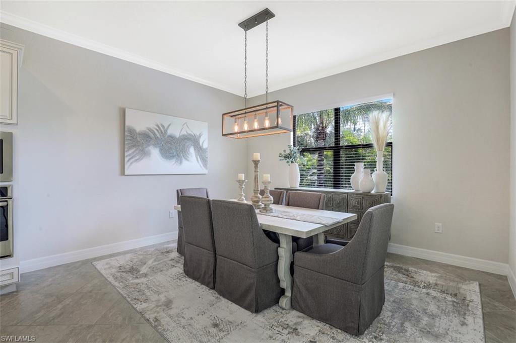 2134 Antigua Lane Naples, FL 34120 - Photo 10 of 31 a view of a dining room with furniture window and wooden floor