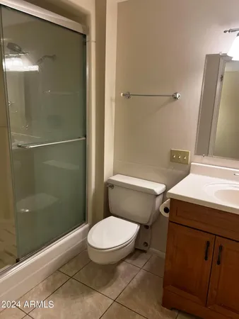 a white toilet sitting next to a bathroom sink