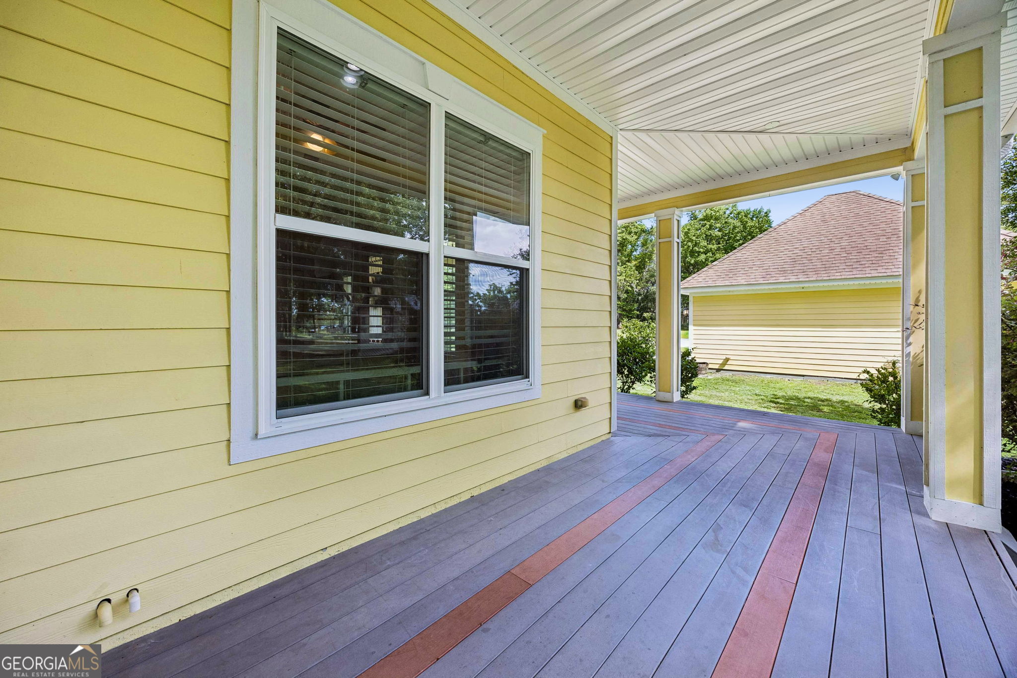 706 Hopewell Point Road White Oak, GA 31568 - Photo 59 of 84 The expansive wraparound porch provides multiple areas to relax while seamlessly connecting the home's indoor and outdoor living spaces.