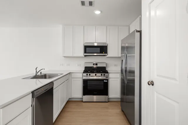a kitchen with a stove and a sink