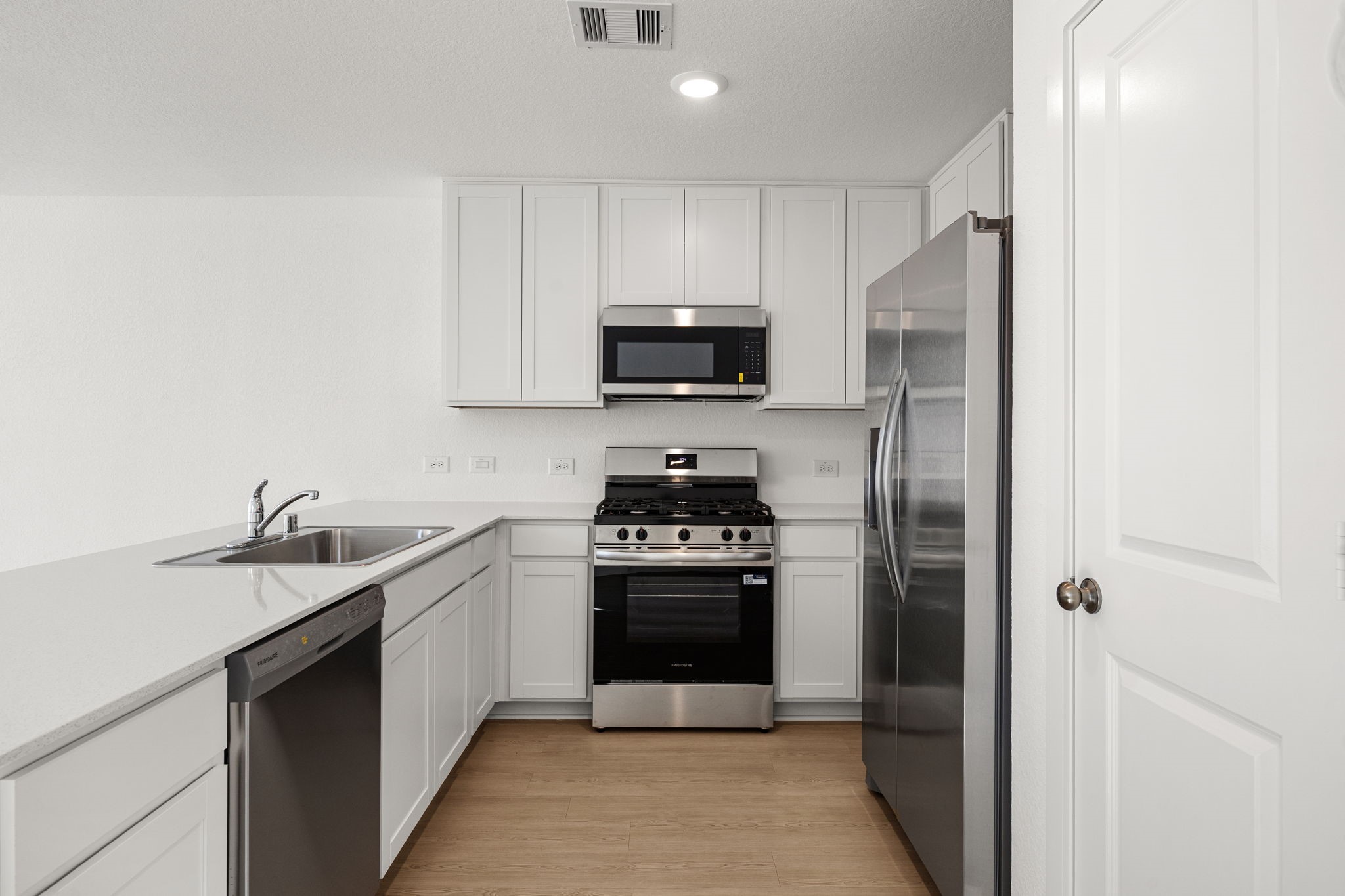 31433 Moore Road Magnolia, TX 77354 - Photo 9 of 25 a kitchen with a stove and a sink