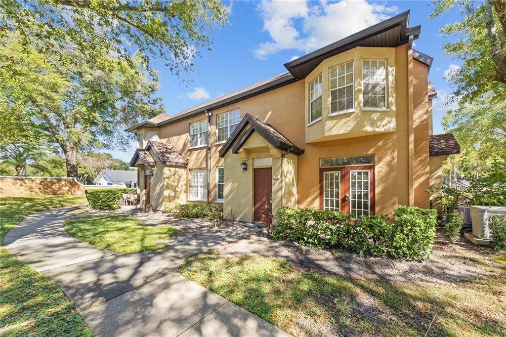6340 Raleigh Street, Unit 1011 Orlando, FL 32835 - Photo 1 of 68 a view of a house with a small yard